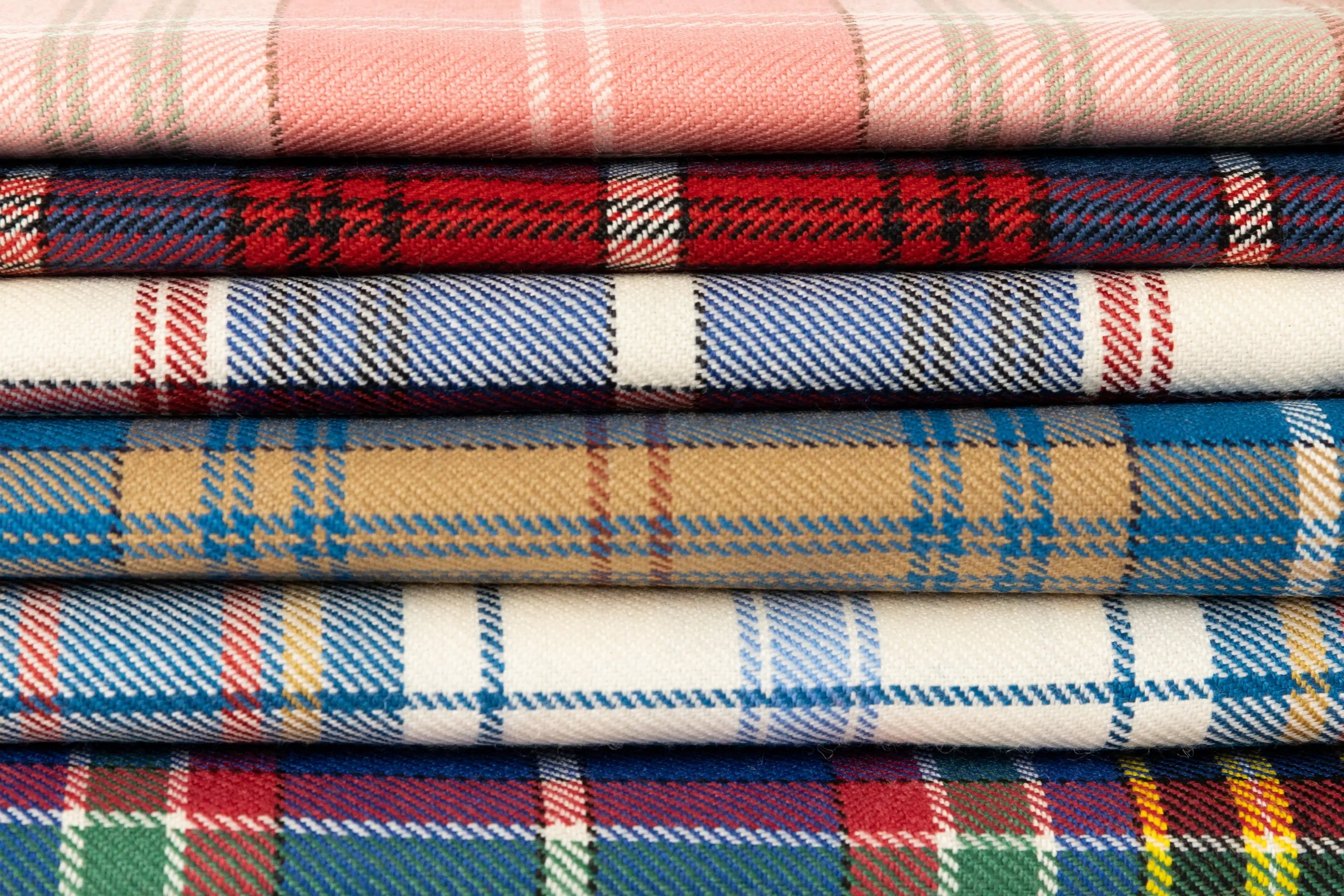 Stack of tartan fabrics in various colors