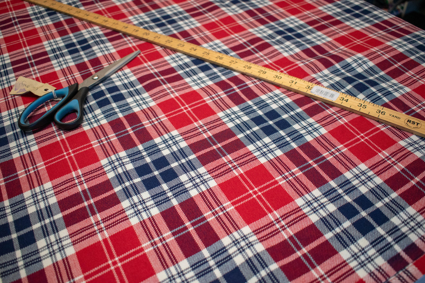 Polish tartan cloth on table with ruler and scissors