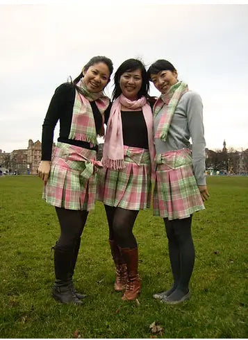 Three women wearing Sakura Japanese tartan skirts