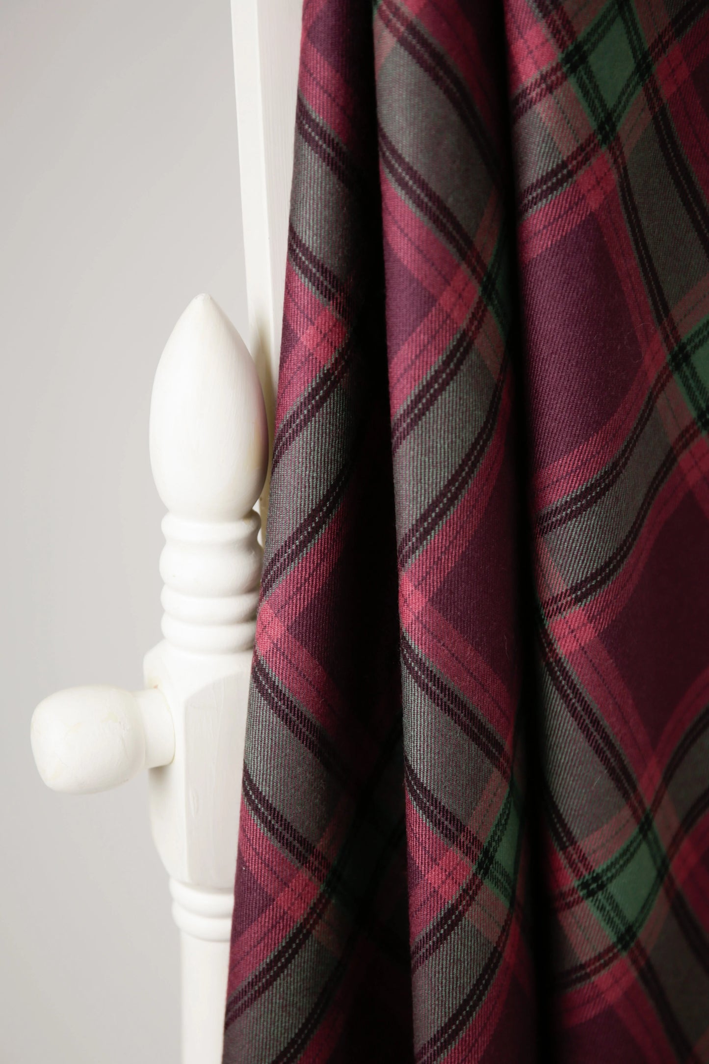 handmade tartan shawl draped over a chair in 100% wool 