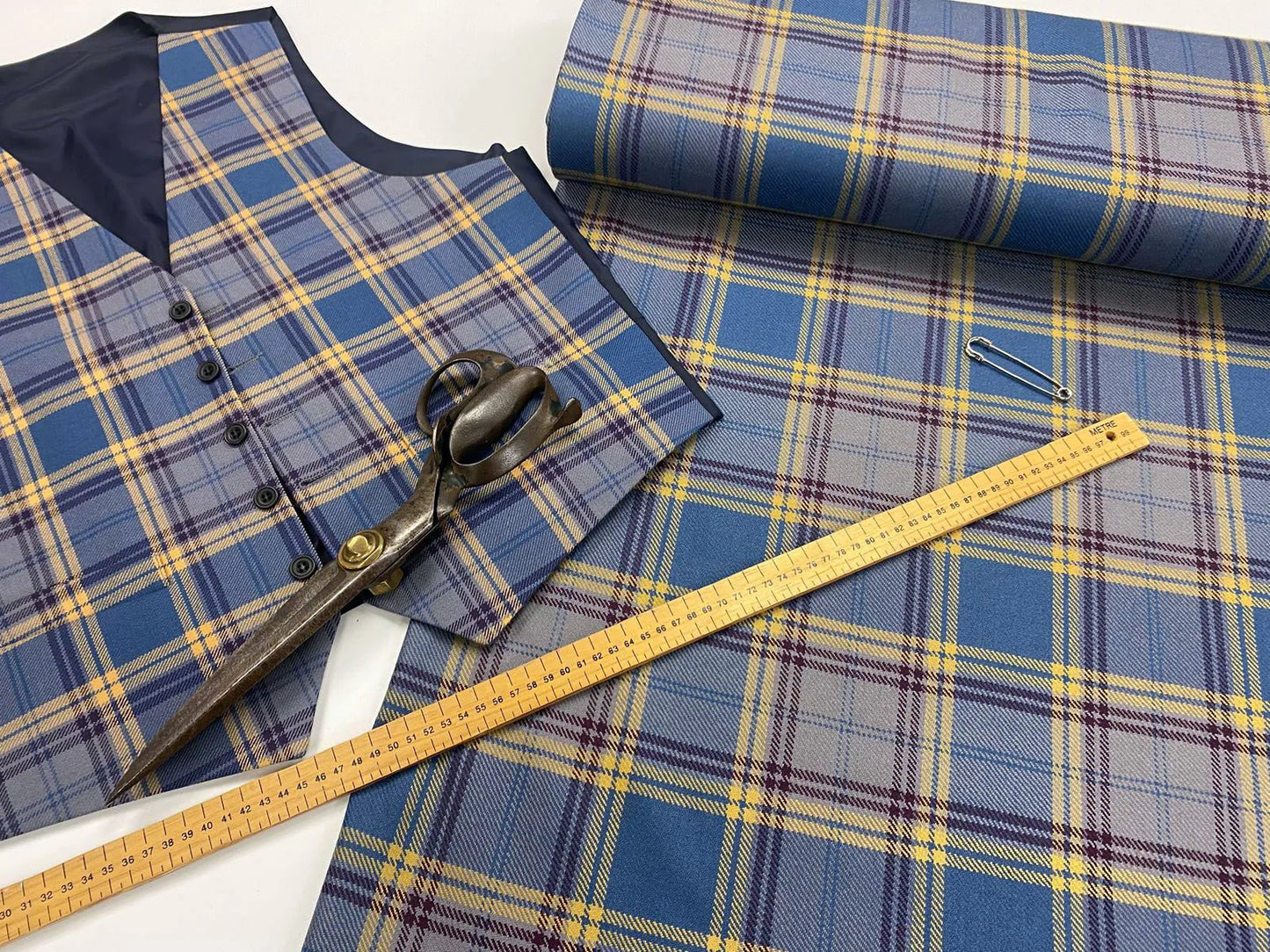 Tartan waistcoat with cloth, scissors and ruler