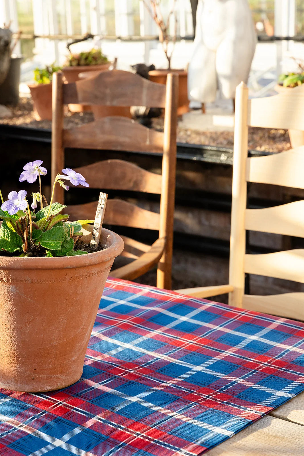 Norwegian tartan fabric laid on table with flower pot