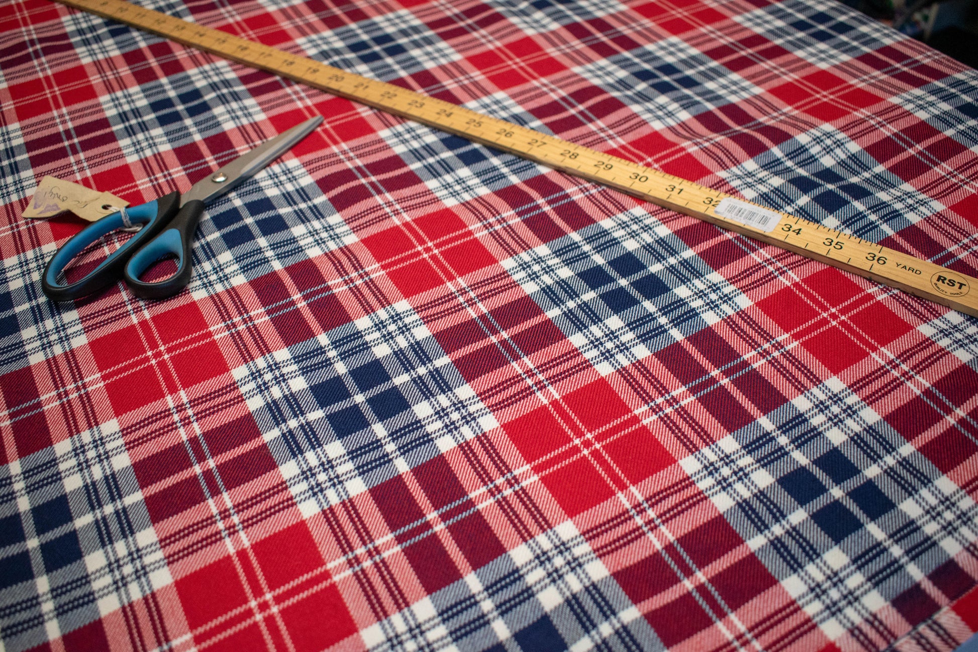 Polish tartan cloth on table with ruler and scissors